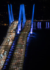 Blue lights on bridge with cars commuting