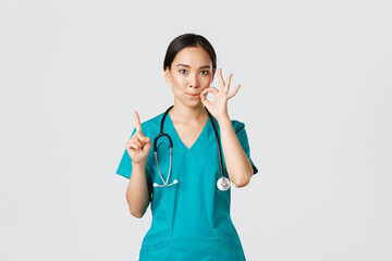 Covid-19, healthcare workers, pandemic concept. Serious-looking worried asian female nurse,...
