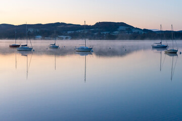 Boats at sunrise on Windermere in Lake District