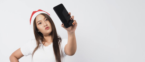 Woman and smartphone. Asian woman with smartphone in hand which posing like selfie or video call for online celebration in Christmas and new year festival season. Teenage braces happy and smartphone.