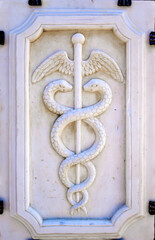 closeup of an antique Caduceus sign