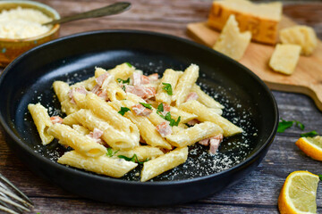  Fresh home made italian  penne  pasta   alla carbonara with  cream sauce  ,  bacon,egg, parmesan cheese ,olive oil and black pepper) 