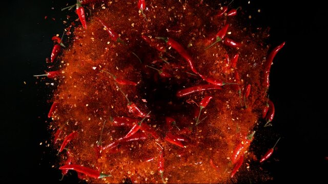 Super Slow Motion Shot of Rotating Red Chilli Peppers with Powder, Filmed on High Speed Cinematic Camera at 1000 fps.