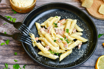  Fresh home made italian  penne  pasta   alla carbonara with  cream sauce  ,  bacon,egg, parmesan cheese ,olive oil and black pepper) 