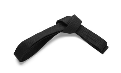 Tied black belt on white background, top view. Oriental martial arts