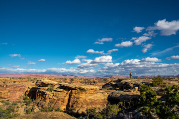 Man on the rock in the Canyonland. Beautiful sky and landscape in the park