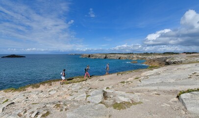 People,walking along the wild coast at the Quiberion peninsula in Brittany France
