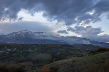 Obraz na płótnie Canvas View of the Majella mountain in Abruzzo Italy with snowy peak and sky with clouds