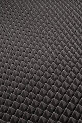 Dark gray triangular acoustic and studio sound proof foam pattern texture. Shock proof foam. The...
