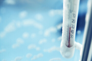 Classic mercury thermometer for measuring ambient temperature, hanging outside the window, with readings minus 30 degrees Celsius.