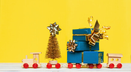 Merry Christmas and happy New Year card celebration old craft styling, train 2022 with Christmas presents box on yellow and blue background