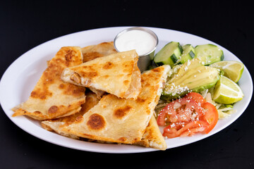 meat and cheese Quesadilla with a side salad