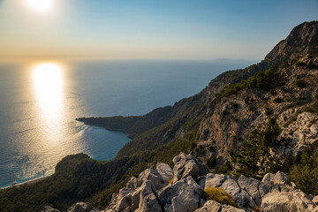 Lycian way hiking and trekking route with sea view at sunset in Turkish Mediterranean area with rocks, mountains. Mountain landscape image taken on the Lycian way trek in Turkey	
