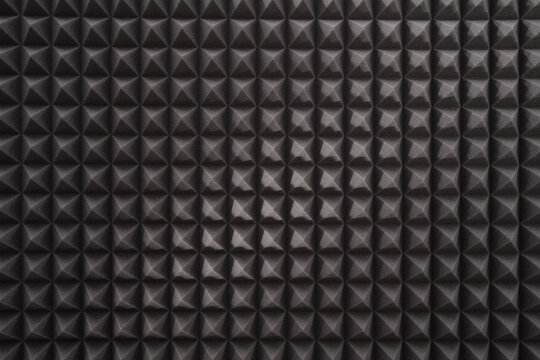Triangular acoustic foam rubber. Sound proof pattern texture wall in sound studio. Background of sound absorbing sponge.