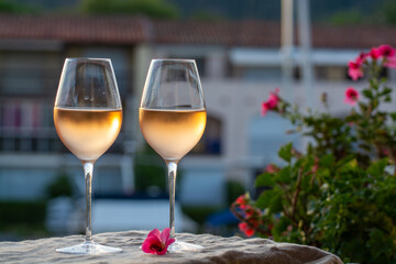 Tasting of local rose wine in summer with sail boats haven of Port Grimaud on background, Provence, France