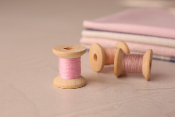 Fototapeta na wymiar Set of color sewing threads on light grey table