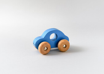 Blue wooden toy car on a white seamless background