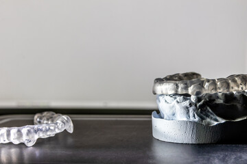 Dental splint against bruxism and grinding teeth with teeth imprint and dental healthcare of an orthodontist as dental protection in a medical dentistry is important to keep the teeth healthy © sunakri