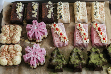 closeup various handmade vegan and sweet chocolate cakes on a kitchen tray
