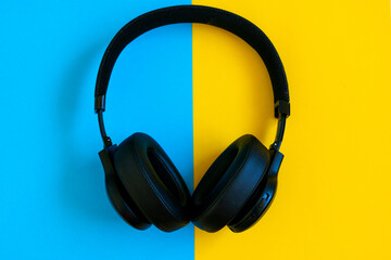 Fototapeta na wymiar headphones isolated on blue and yellow background