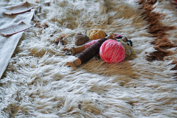 Balls of colored yarn on homemade kitenik