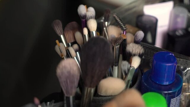 A set of professional makeup brushes. Make-up artist tools for applying decorative cosmetics - shadows, powder, lipstick, blush. Female beauty. Natural brushes applicators in a case for MUA or visage.