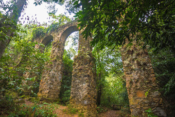 Fototapeta na wymiar View of the ruins of an old aqueduct at Ilha Grande - Ilha Grande, Angra dos Reis, Brazil