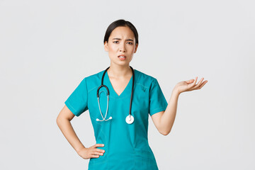 Covid-19, healthcare workers, pandemic concept. Frustrated and annoyed asian female doctor, nurse...