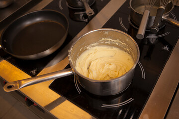 Close up top view shot of mashed potatoes in a boiling pot on the stove