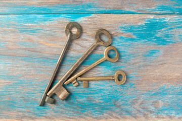 Old metal keys on wooden background