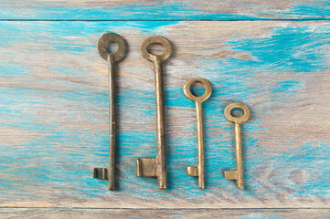 Old metal keys on wooden background