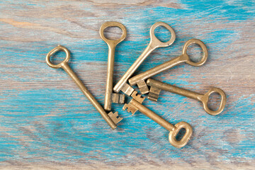 Old metal keys on wooden background