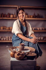 Pottery master demonstrates a finished clay bowl in the workshop . Making pottery.