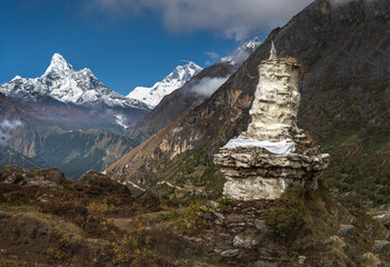 ancient buddha stupa in valley with view to summit Ama Dablam in Nepal
