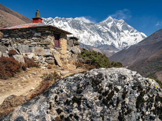 view to old farm house on the stone hill with view to summit Lhotse (8512m) in valley Khumbu in...