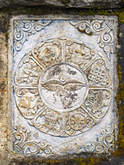 close up view to stone runa symbols on old tomb in Nepal