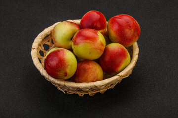 Sweet small nectarines in the basket