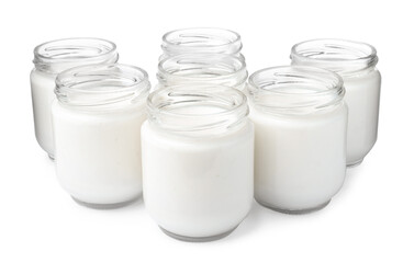 Glass jars with delicious homemade yogurt on white background