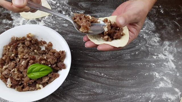 prepare manti stuffed with meat dough for khinkali dumplings or dumplings. preparation of dough and meat dishes