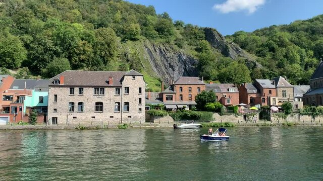 Skyline of Dinant town. Eglise Saint Paul des Rivages stone church and brick houses on the riverfront. Belgian Ardennes. Dinant, Province of Namur, Belgium- 
