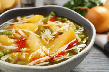 Bowl of delicious turnip soup on grey table, closeup