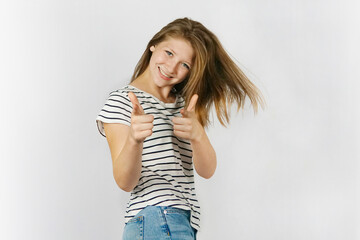 Smiling happy girl woman pointing at the camera with both hands and her head