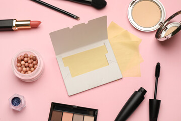 Facial oil blotting tissues and different decorative cosmetics on pink background, flat lay. Mattifying wipes