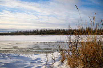 Landscape of late autumn. River view. The first snow.