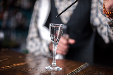 Barman makes a cocktail at the public house