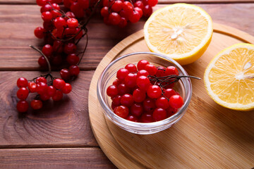 Viburnum with lemon on a wooden background
