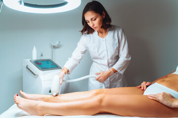 Laser epilation and cosmetology in beauty salon. Laser hair removal, skin care. Master dolaser hair remove prosedure.