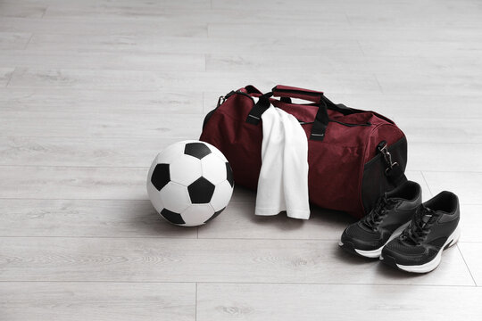 Sports bag with training stuff and equipment on white floor