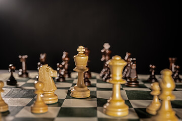 Playing chess on a foldable board. Close ups of some important pieces. 
