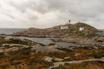 Fototapeta na wymiar Lindesnes Fyr Lighthouse, Beautiful Nature Norway natural landscape aerial photography. South Norway. Yachting. Sailing. Waves. Cloudy weather. 